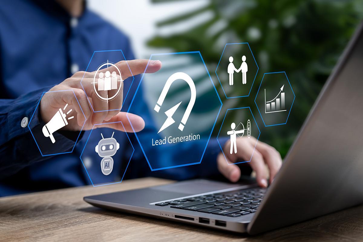 man in front of a laptop reaching out to touch graphic representation of lead generation 